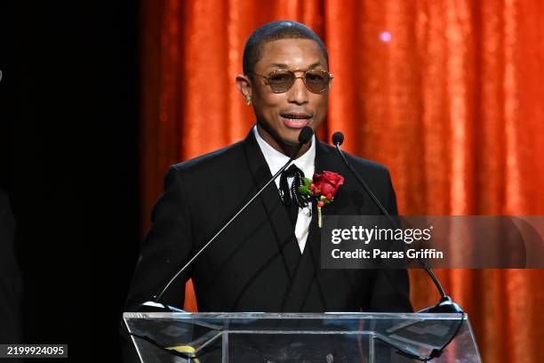 Pharrell Williams accepts the Candle In Arts and Entertainment Award during the 37th Annual Morehouse College "A Candle in the Dark" gala at Hyatt...