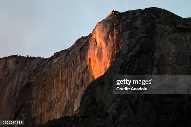 View of Firefall effect on El Capitan during sunset at Horsetail Fall as hundreds of tourists and photographers flock in Yosemite National Park,...