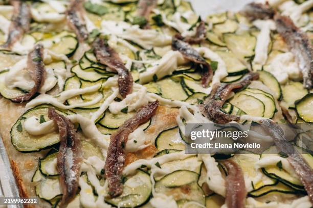 close-up of the texture of italian pizza with zucchini, strachatella and anchovies. italian food, a holiday destination in italy - anchovy pizza stock pictures, royalty-free photos & images