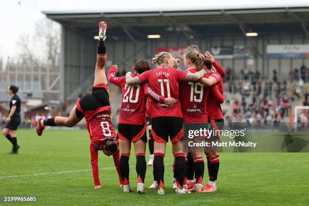 Elisabeth Terland of Manchester United celebrates scoring her team's second goal with teammates while Grace Clinton of Manchester United does a...