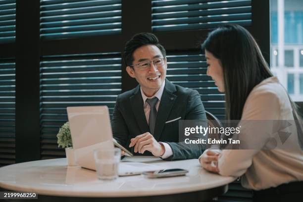 asian chinese businessman discussion with his client in cafe - chinese ethnicity stock pictures, royalty-free photos & images