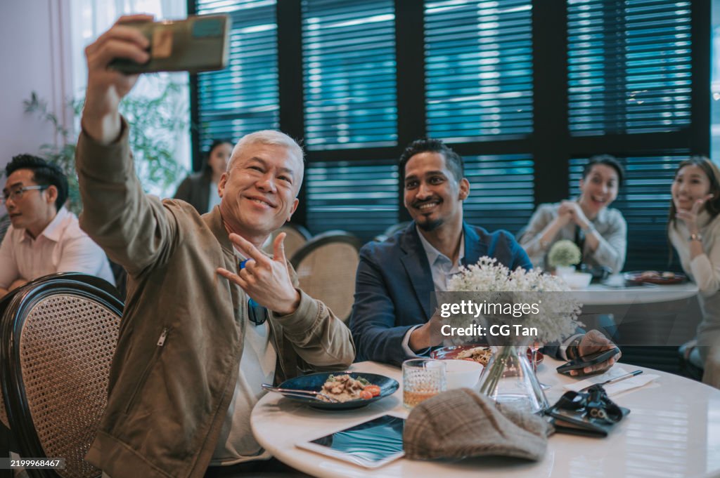 Asian friends selfie at restaurant social gathering