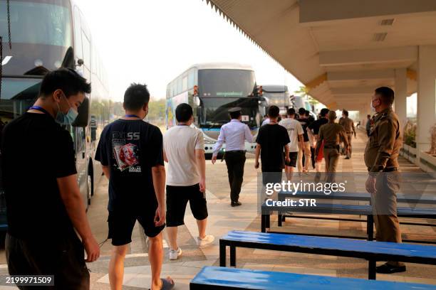 Alleged scam centre workers and victims from China arrive at the border checkpoint with Thailand in Myanmar's eastern Myawaddy township on February...