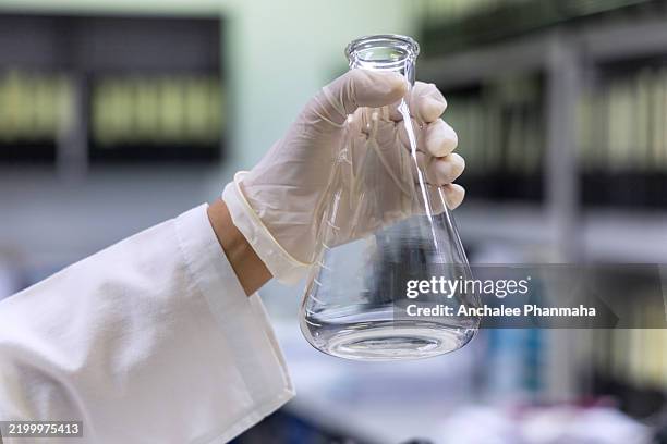 the chemist is testing by using titration technic in laboratory - titration stock pictures, royalty-free photos & images