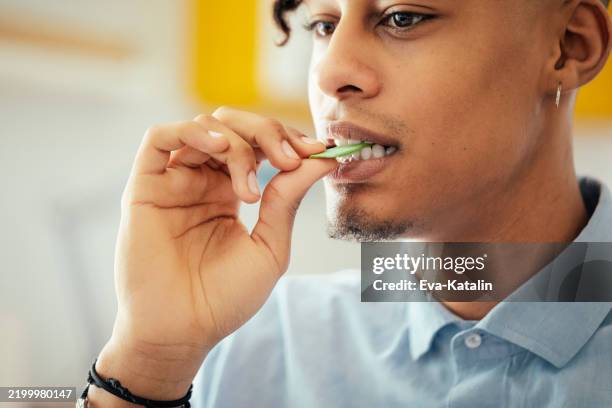 young man at home - bubble gum stock pictures, royalty-free photos & images