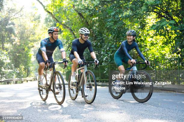 asian chinese enthusiast cyclists in singapore riding in nature park - cyclist stock pictures, royalty-free photos & images