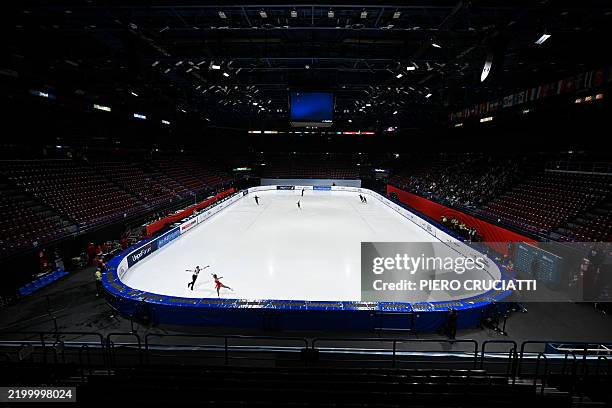 Athletes warm up before the Pair Skating - Free Skating program at the Milano Ice Skating arena in Milan during the Skating - Road to 26 Trophy...