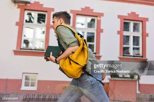 student sprinting with backpack and books - top priority stock pictures, royalty-free photos & images