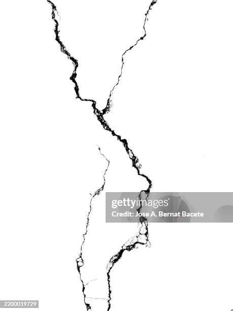 deep cracks and fissures on a white background. - rotto foto e immagini stock