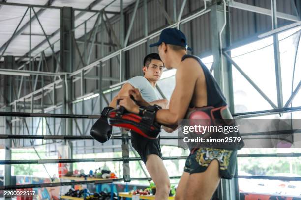 training beyond age: kickboxing with experience and focus - combat sport stock pictures, royalty-free photos & images