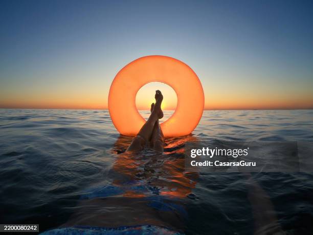 perfect summertime vacation sunset - women forties feet stock pictures, royalty-free photos & images