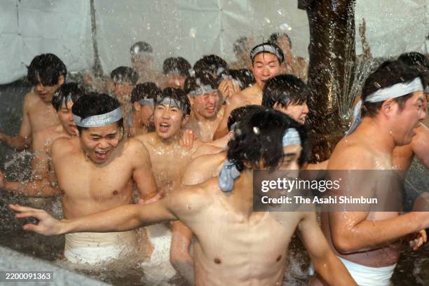 Participants purify their bodies in a fountain before entering the temple at the Naked Festival, or Hadaka Matsuri at Saidaiji Temple on February 15,...