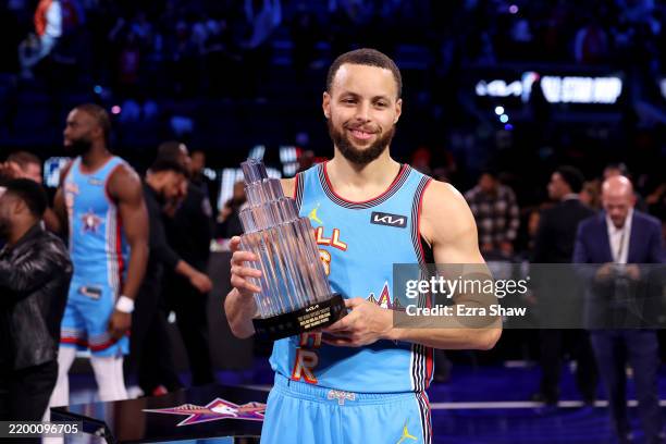 Stephen Curry of the Golden State Warriors and Shaq's OGs poses with the 2025 KIA Kobe Bryant MVP trophy during the 74th NBA All-Star Game at Chase...