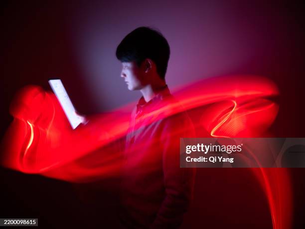 businessman using digital tablet, long exposure of led light - red led stock pictures, royalty-free photos & images