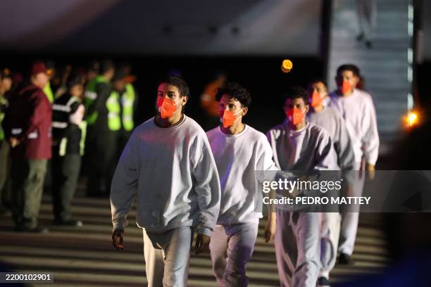 Venezuelan migrants deported from US Naval Station Guantanamo Bay walk down from the Venezuelan Conviasa Airlines plane as they arrive at Simon...