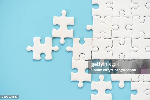white jigsaw puzzle on blue background - complementary angles stock pictures, royalty-free photos & images