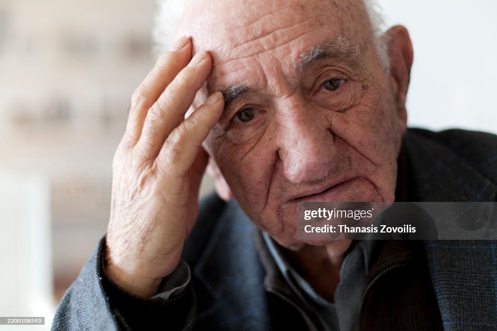 Elderly man showing signs of contemplation in a quiet space