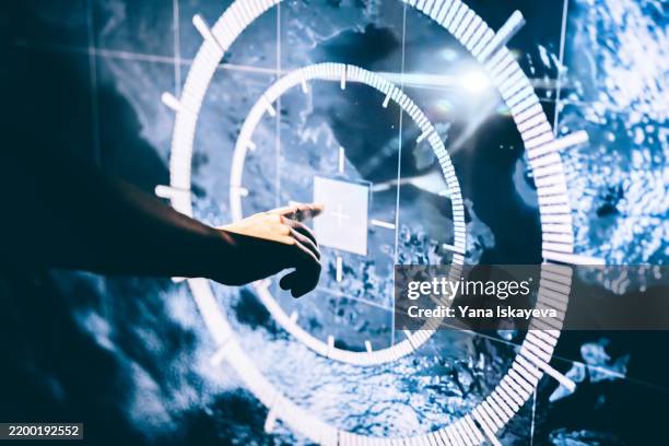 interactive digital display showing futuristic interface with hand gesture input - militär stock-fotos und bilder