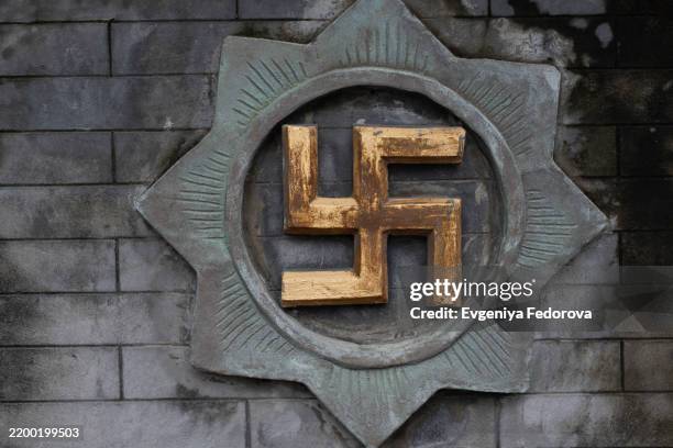 swastika is an ancient sign wishing good luck - nazi swastika stock pictures, royalty-free photos & images