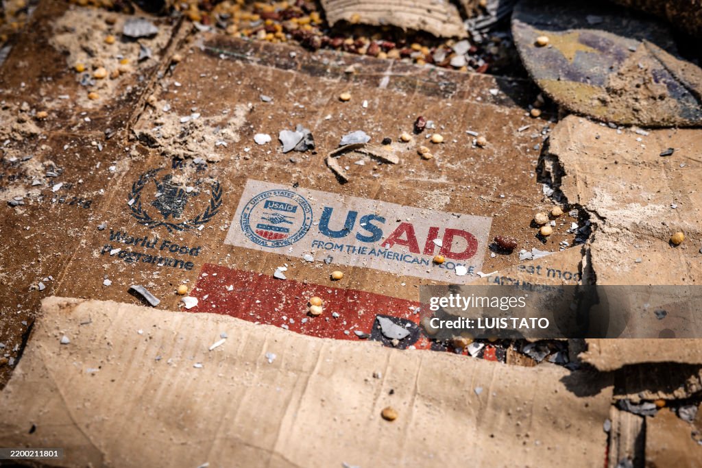 Usaid Rdc USAID logo is visible on a box amid the scattered remains of boxes ...