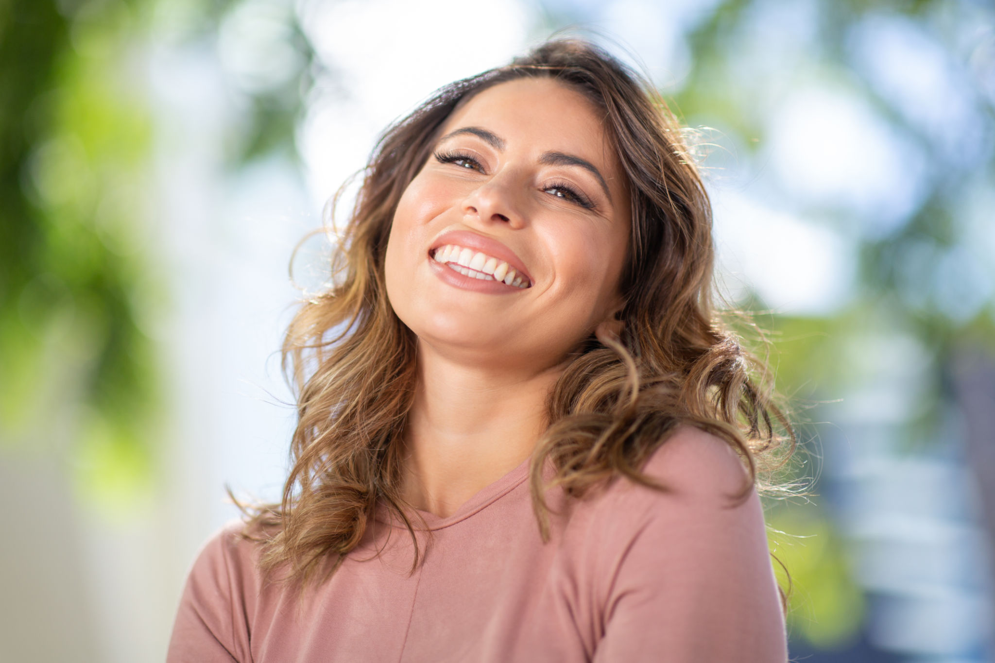 Close up happy young woman smiling outdoors Close up happy young woman smiling outdoors