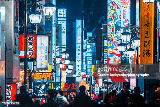 shinjuku capital hall in tokyo at night with neon lights - quartiere a luci rosse foto e immagini stock