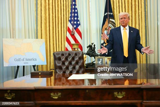 Poster with a map captionned "Gulf of America" is seen as US President Donald Trump speaks by the signed commission to make Howard Lutnick US...