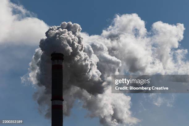 smoke rises from a chimney - climate crisis stock pictures, royalty-free photos & images