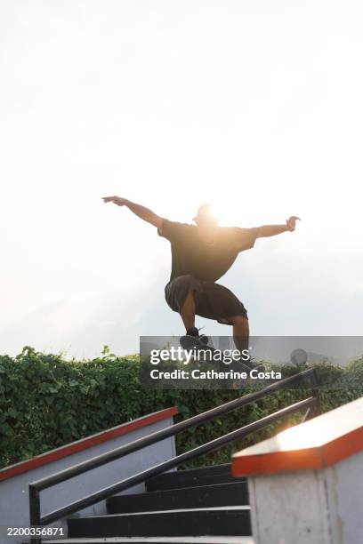 skateboarder in action midair - skateboarder stock pictures, royalty-free photos & images