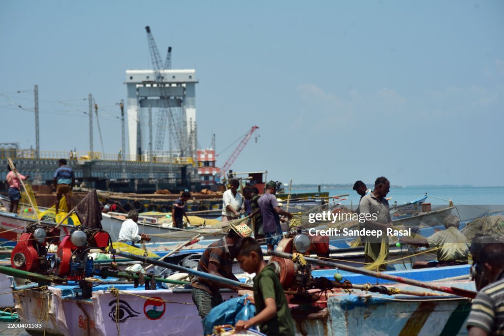 Fishermen removing fresh catch near Old Pamban bridge built in 1914 and on going construction of new Pamban Bridge