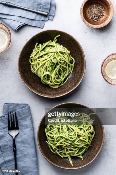 bowl of spaghetti with fresh herbs pesto, vegan dish - pesto sauce stock pictures, royalty-free photos & images