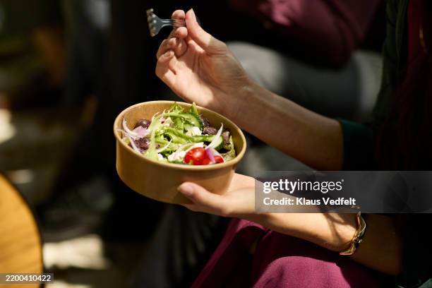 businesswoman eating salad with fork - salad bowl stock pictures, royalty-free photos & images
