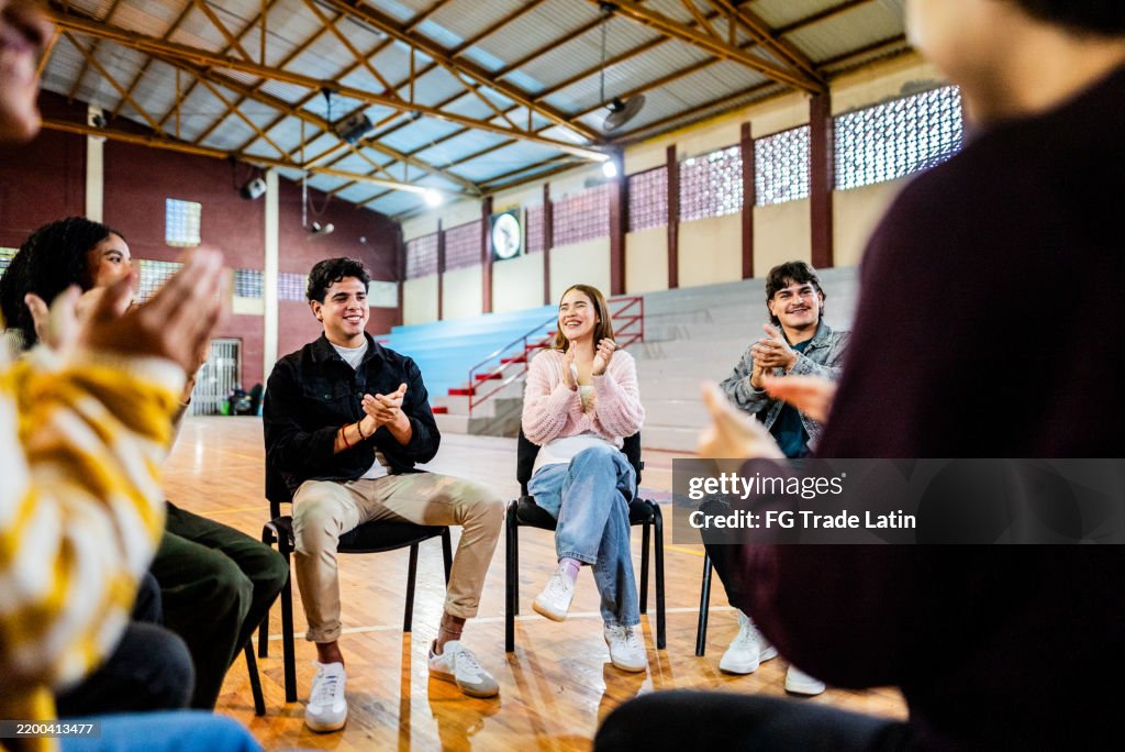 Young people applauding during group therapy