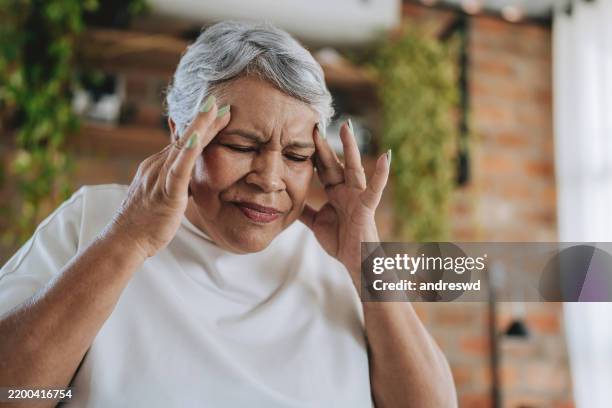 woman senior with headache - dizzy stock pictures, royalty-free photos & images