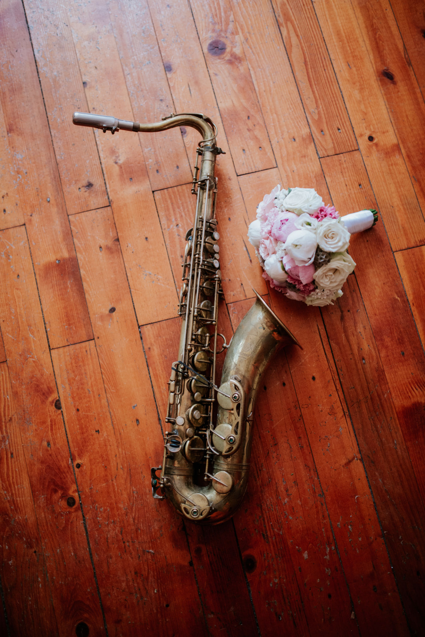 Vintage Saxophone and Bridal Bouquet on Rustic Wooden Floor Vintage Saxophone and Bridal Bouquet on Rustic Wooden Floor