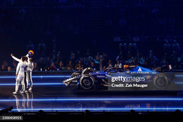 James Vowles, Team Principal of Williams, Alexander Albon of Thailand and Williams and Carlos Sainz of Spain and Williams take a selfie with their...