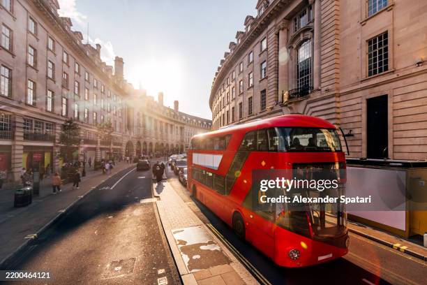 red double-decker bus on regent street on a sunny day, london, england, uk - oxford street london stock pictures, royalty-free photos & images