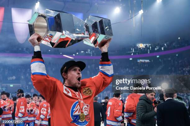 Mikko Lehtonen of ZSC Lions holds the trophy and celebrates the victory in front of fans after the Champions Hockey League Final 2025 between ZSC...