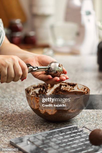 a woman preparing chocolate truffles - cake batter stock pictures, royalty-free photos & images