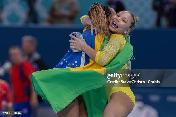 Rebeca Andrade of Brazil is congratulated by teammate Flavia Saraiva after winning the Silver Medal during the Women's Individual All Around Artistic...