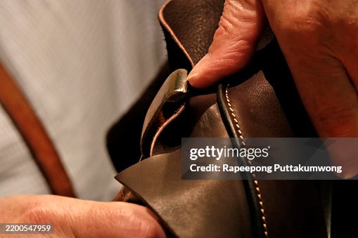 A saddle maker making a custom made saddle. A saddle maker making a custom made saddle.