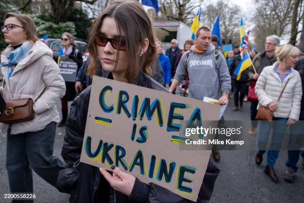 Ukrainians and supporters of Ukraine gather to march towards the Russian Embassy in protest of the continued war prior to the third anniversary of...