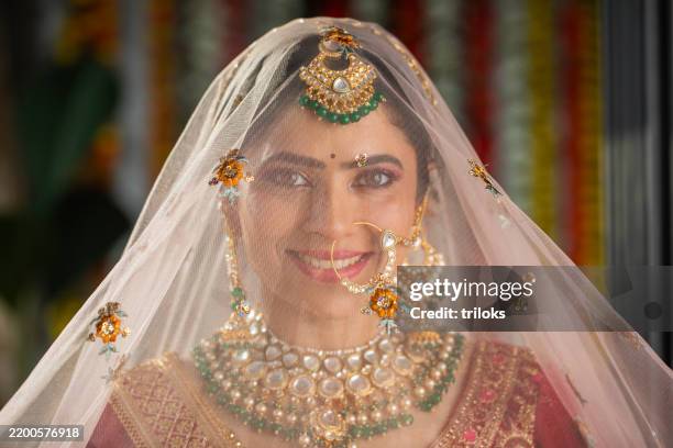 portrait of happy bride looking through her white veil in wedding ceremony - bride stock pictures, royalty-free photos & images