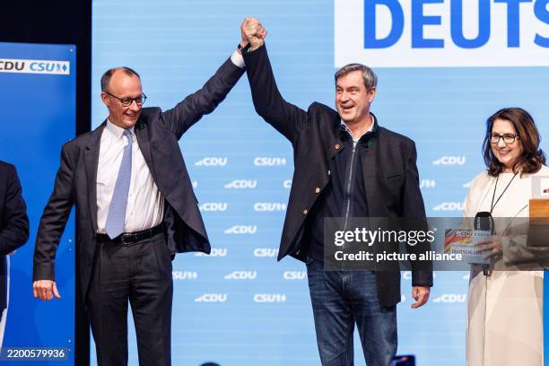 February 2025, Bavaria, Munich: Friedrich Merz, Federal Chairman of the CDU and CDU candidate for Chancellor in the 2025 election, and Markus Söder ,...