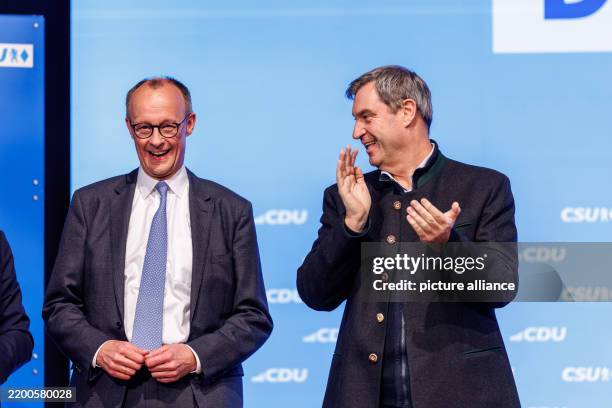 February 2025, Bavaria, Munich: Friedrich Merz, Federal Chairman of the CDU and CDU candidate for Chancellor in the 2025 election, and Markus Söder ,...