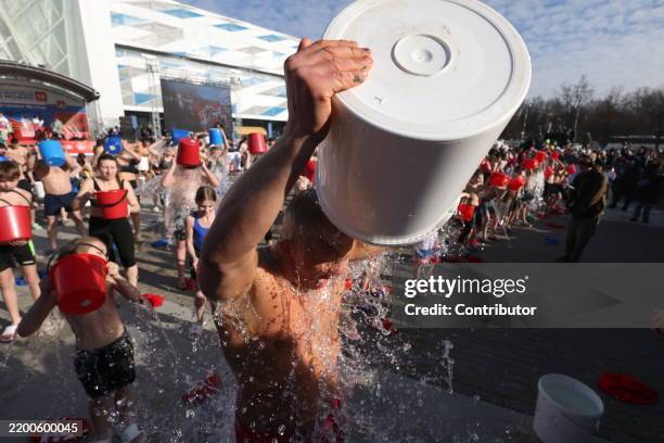 Participants pour icy-cold water over themselves during the "Being Healthy is Fashionable", an event, hosted by the military-sportive club...
