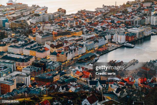 aerial view of bergen, norway from mount floyen with historic waterfront and city lights - bergen foto e immagini stock