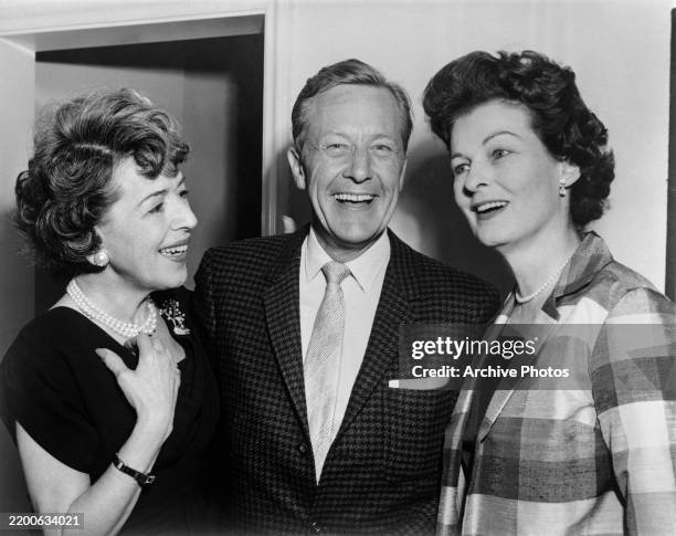 American actress and publicist Helen Ferguson, American actor Gene Raymond, and American actress Ruth Hussey attend a cocktail party at the Hotel...