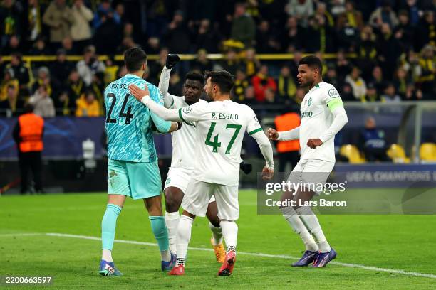 Rui Silva of Sporting CP celebrates with teammates after saving a penalty from Serhou Guirassy of Borussia Dortmund during the UEFA Champions League...