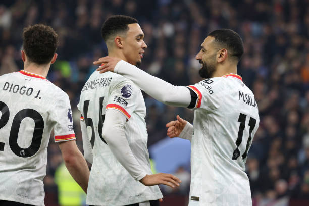 Mohamed Salah of Liverpool celebrates scoring his team's first goal with teammate Trent Alexander-Arnold during the Premier League match between...